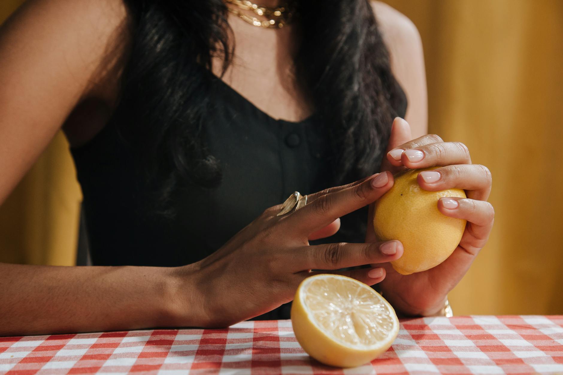 Two hands holding silicone vibrators against a soft pastel background, representing accessible pleasure tools